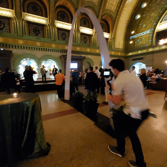 Camera operator filming crowd at presentation